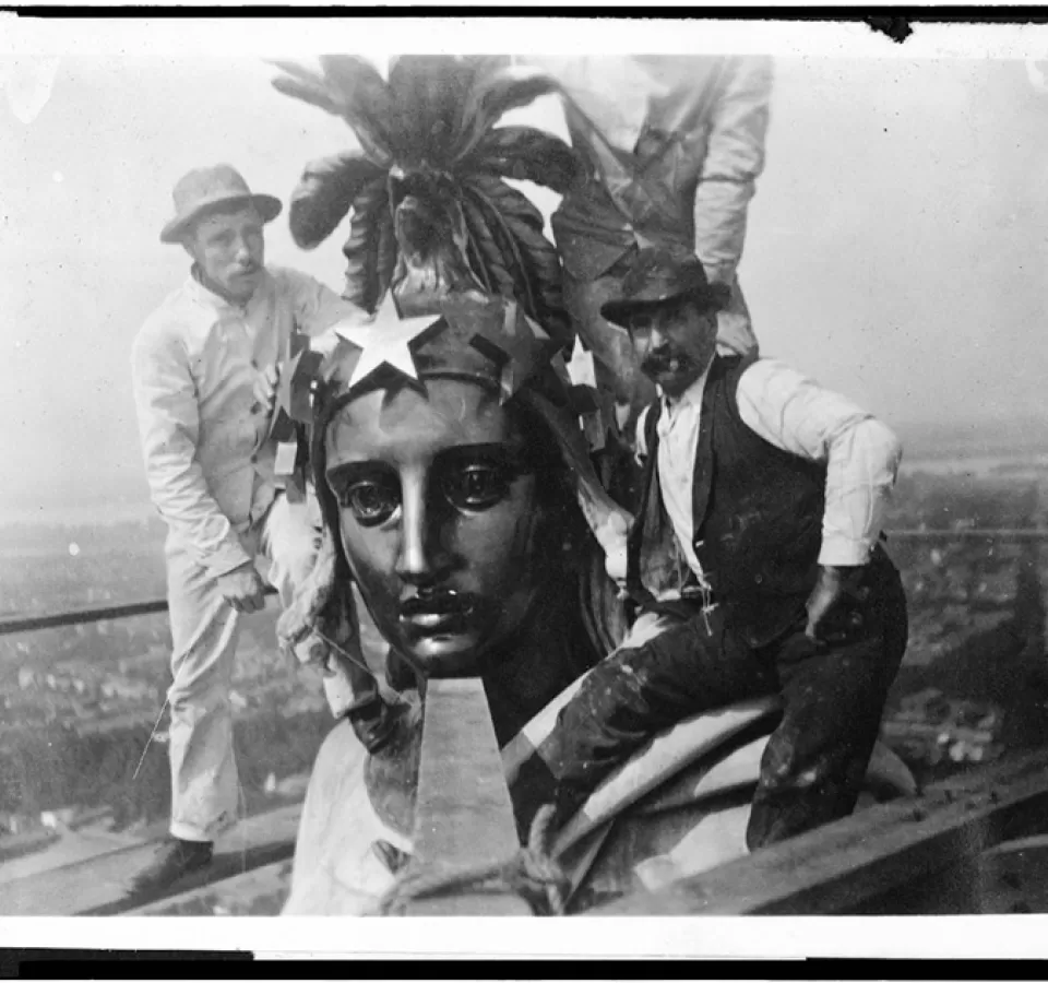 Architect of the Capitol employees take a self-portrait (note string in hand of individual all in white) while preserving the Statue of Freedom in 1913.