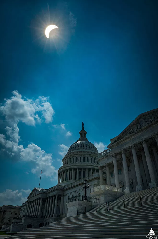 Partial solar eclipse seen above the U.S. Capitol.