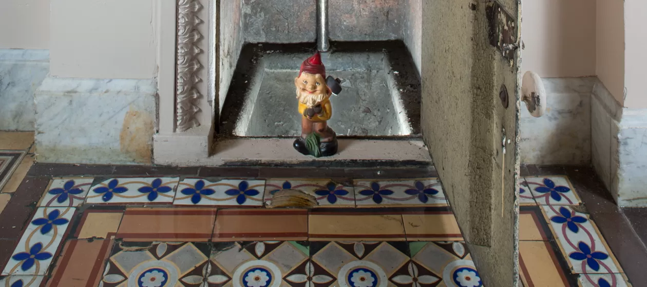 Gnome statue in doorway.