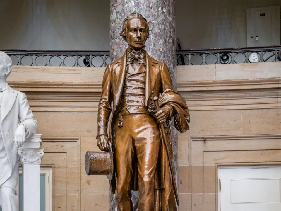 Bronze statue of a person standing.