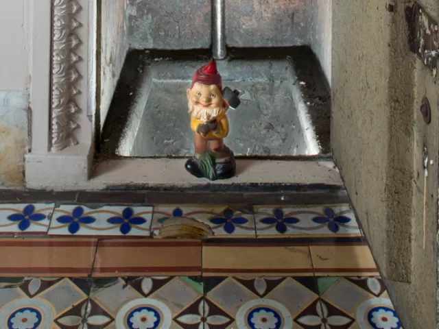 Gnome statue in doorway.