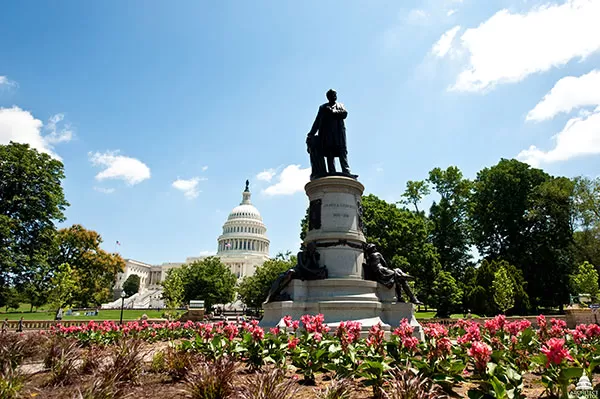 View of Garfield Monument and its summer flower beds with the U.S. Capitol in the background.