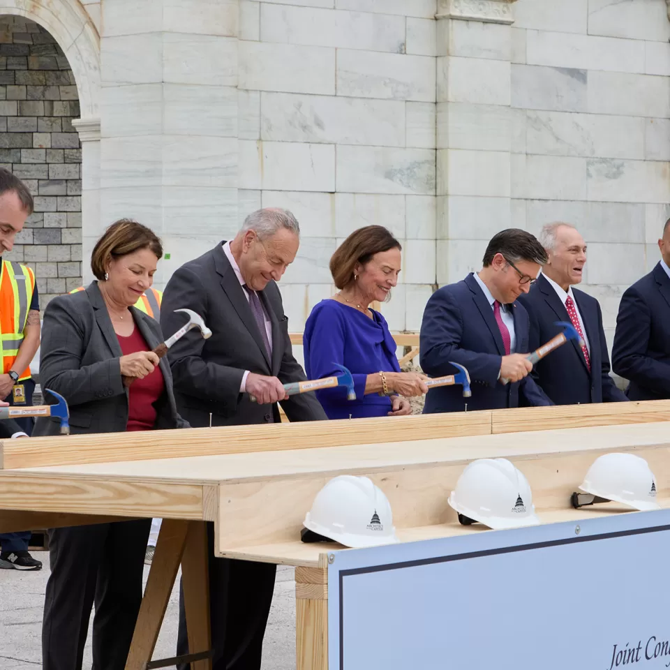 People standing with hammers in hand.