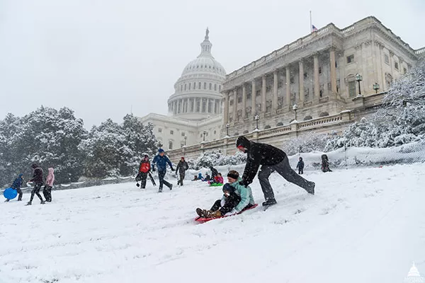 Visitors sledding on the snow at the U.S. Capitol in 2018.