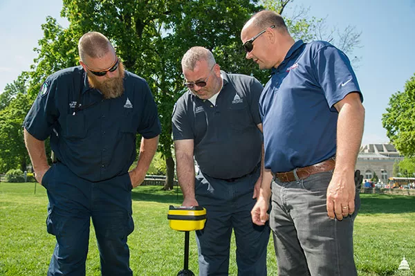 AOC employees test an underground utility locator on the West Front lawn of the U.S. Capitol.