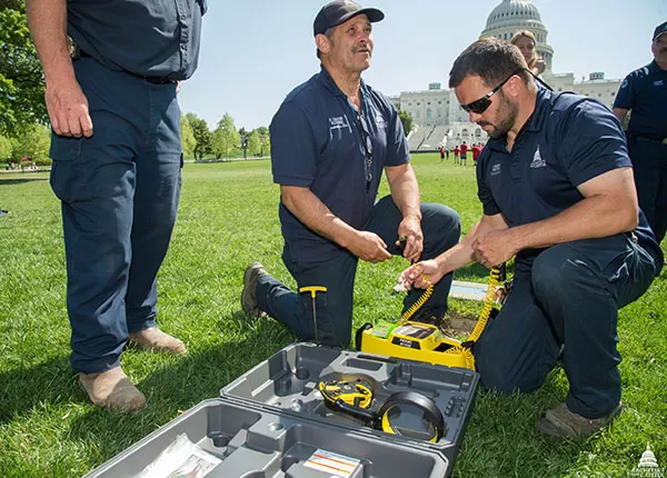 AOC employees test an underground utility locator on the West Front lawn of the U.S. Capitol.