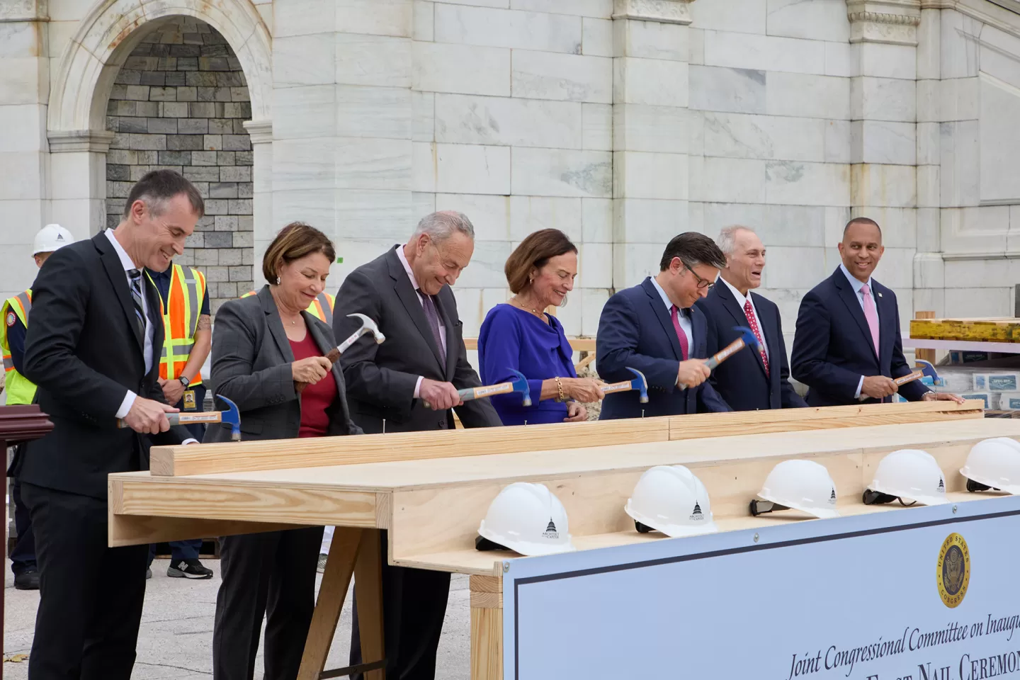 People standing with hammers in hand.