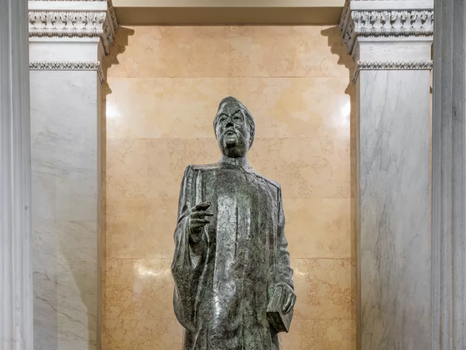 Bronze statue of a person standing.