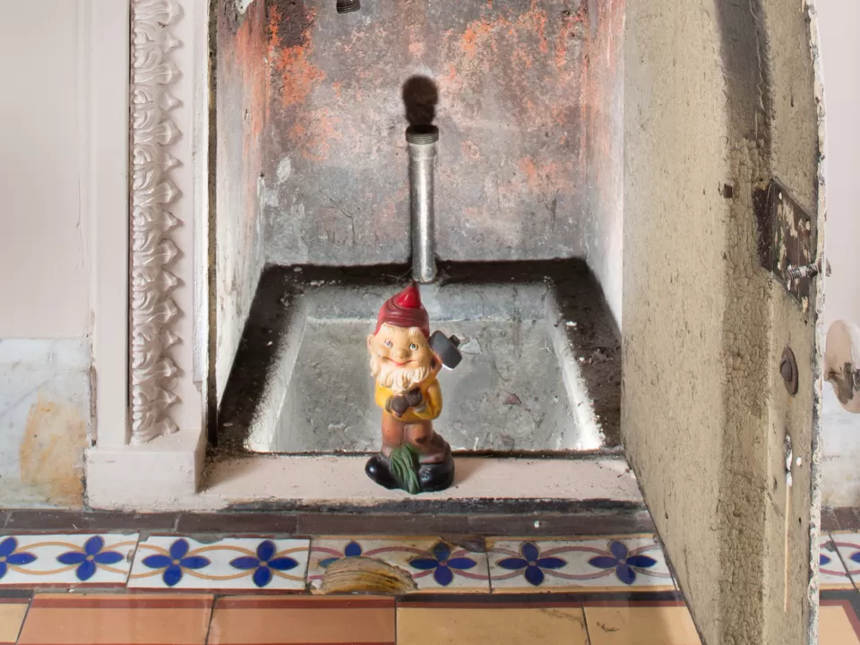 Gnome statue in tiny doorway.