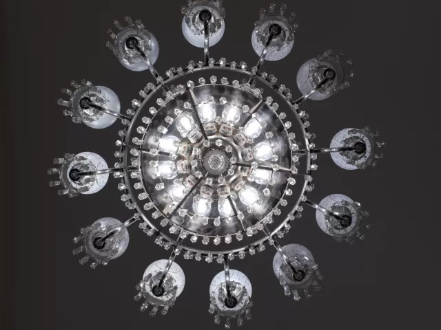 The Caucus Room chandelier, a prominent feature of the space, can be seen in original photos dating to 1908.