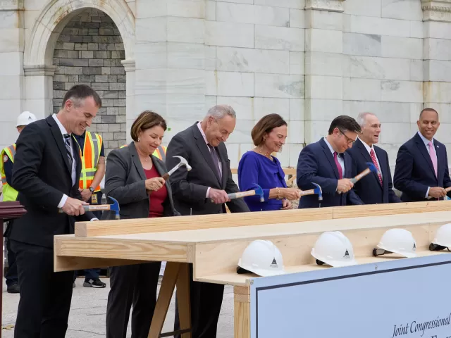 People standing with hammers in hand.